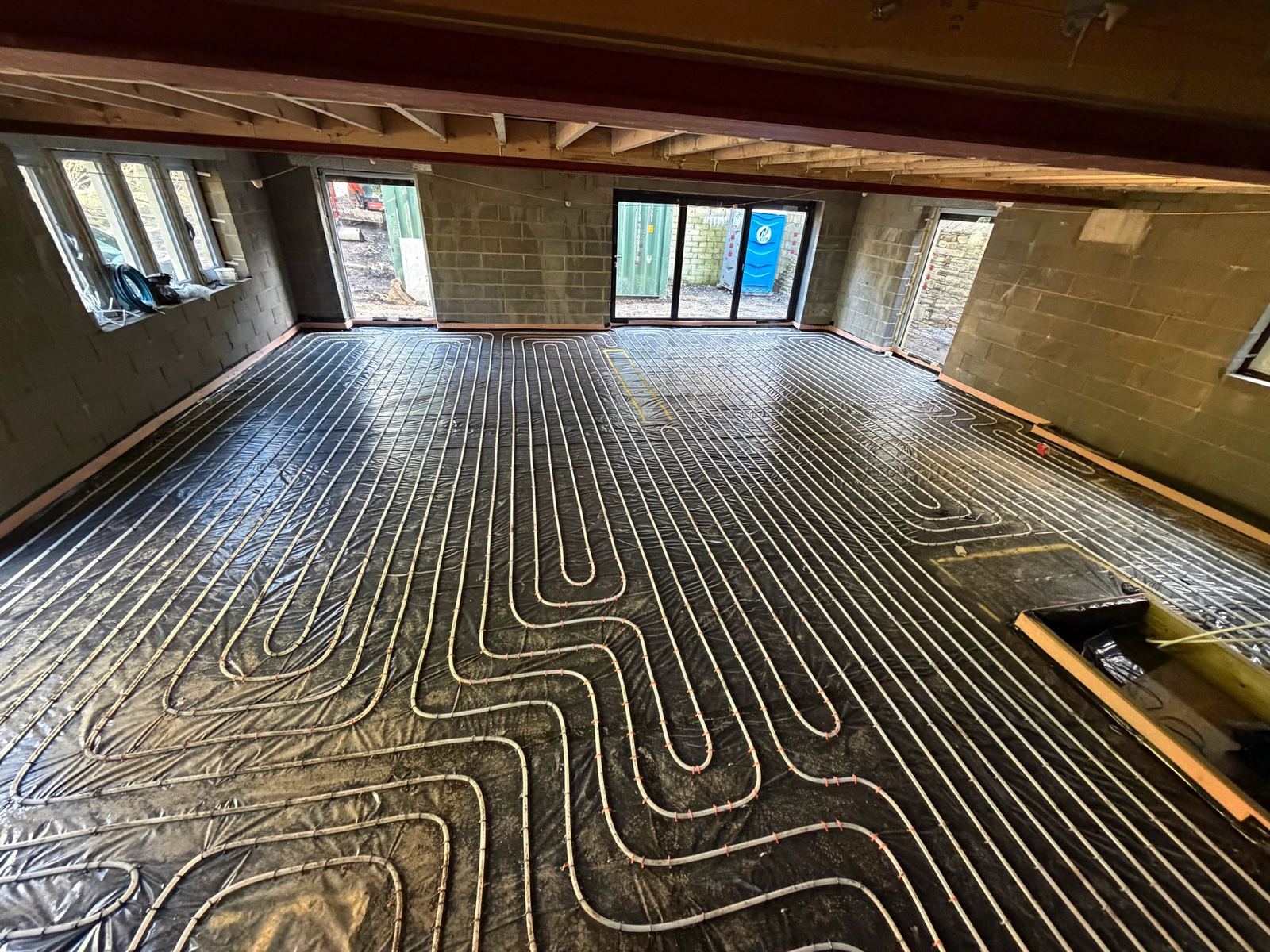 Underfloor heating pipework laid across a large floor area